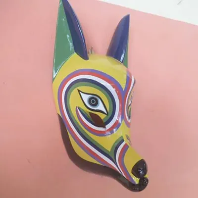Máscara de coyota amarilla con orejas verdes y bandas de arcoíris alrededor de los ojos